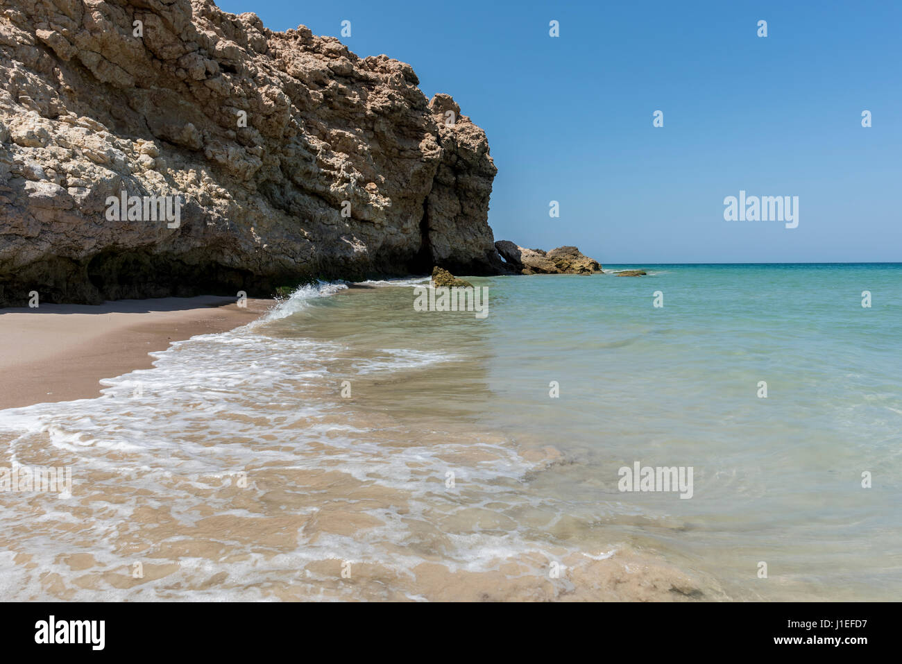 Calm water and wild beach at the coast of Ras Al Jinz, Sultanate of Oman. Horizontal shot with copy space Stock Photo