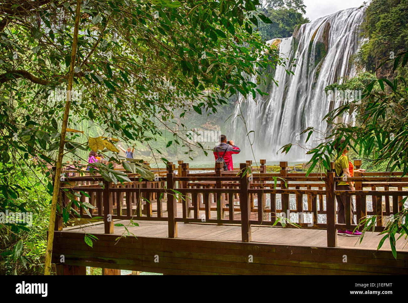 Guizhou Province, China.  Man Taking Picture of the Yellow Fruit Tree (Huangguoshu) Waterfall. Stock Photo