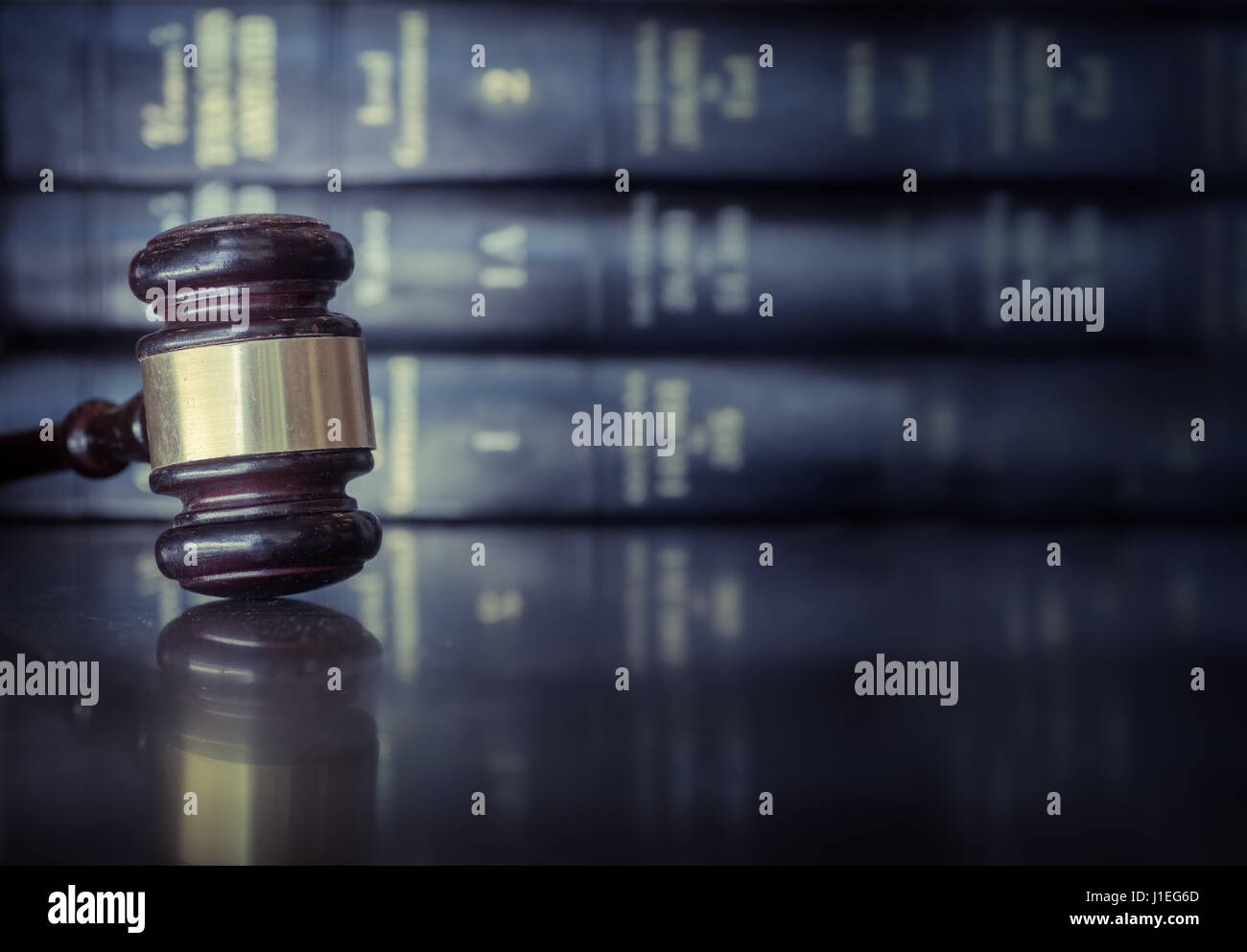 Legal law concept image, gavel on desk with books behind Legal law concept image, gavel on desk