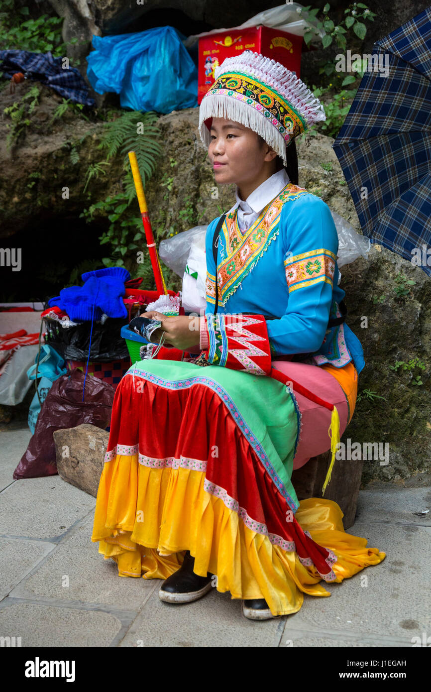 China, Guizhou, Dragon Palace Scenic Area.  Young Woman in Traditional Bouyei Dress. Stock Photo