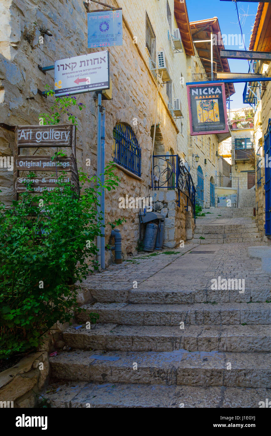 SAFED, ISRAEL - SEPTEMBER 14, 2016: An alley in the Jewish quarter of the old city, with various business signs, in Safed (Tzfat), Israel Stock Photo