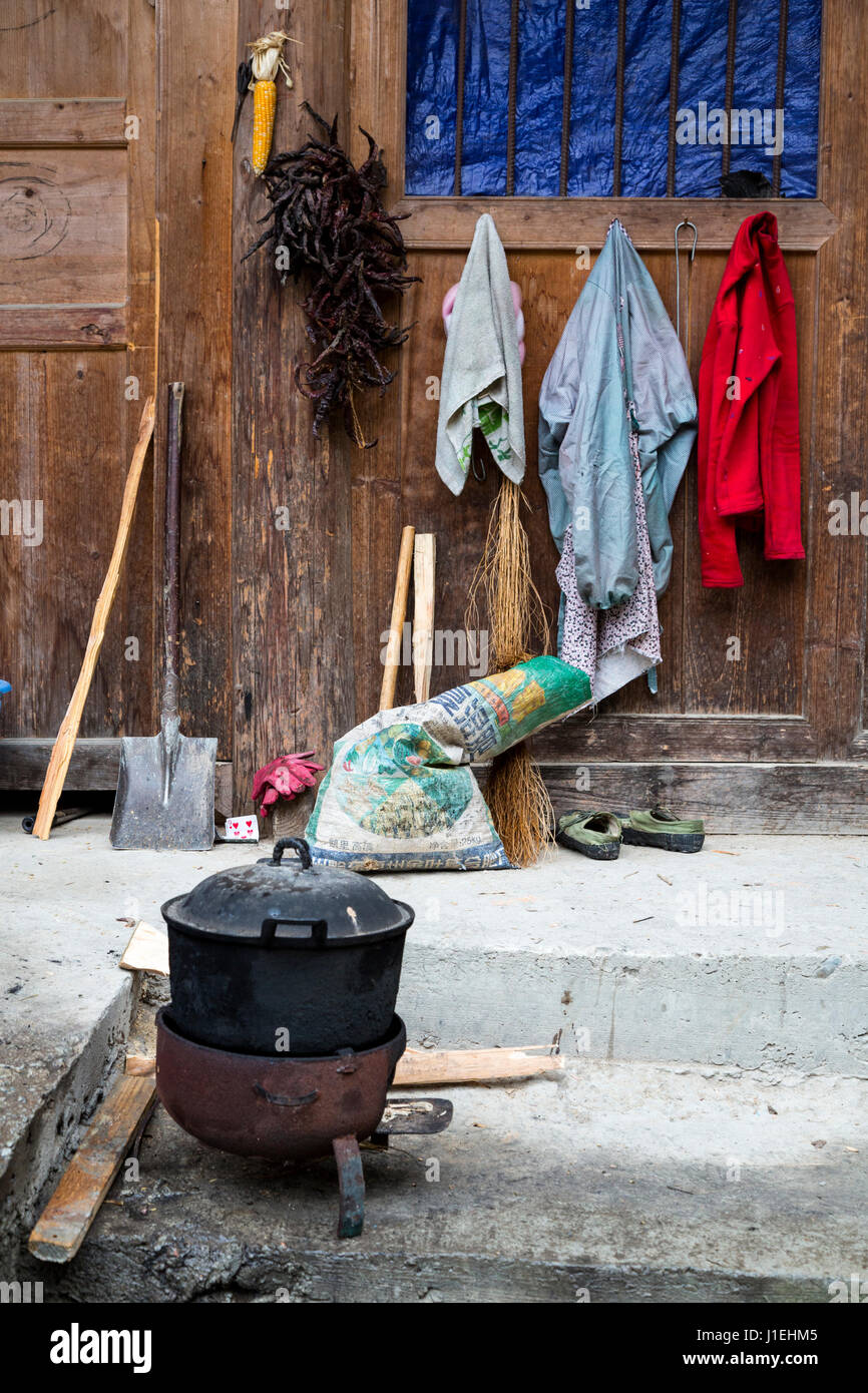 Huanggang, Guizhou, China.  A Dong Ethnic Village.  Cooking Pot, Chilis, Clothes Drying. Stock Photo