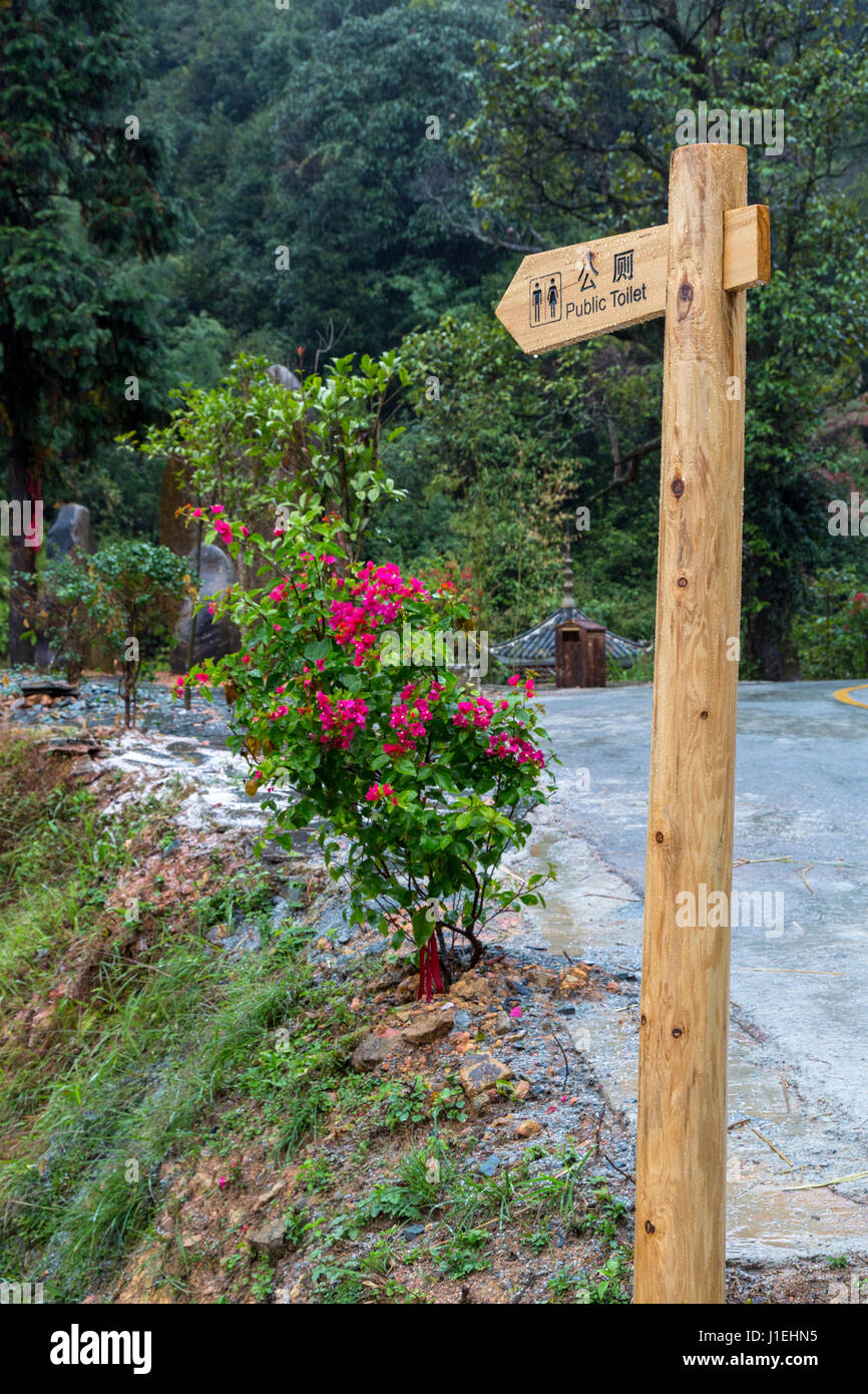 Huanggang, Guizhou, China.  Sign Pointing to Public Toilets for Tourists, A Dong Ethnic Village. Stock Photo