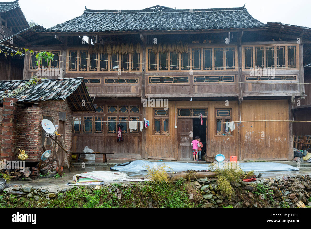 Huanggang, Guizhou, China.  A Dong Ethnic Village.  Private House, Satellite Dish on Left. Stock Photo