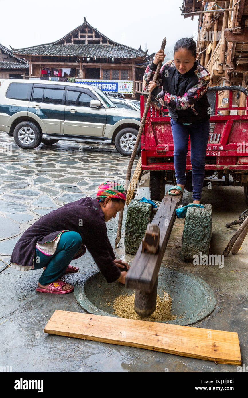 Huanggang, Guizhou, China.  A Dong Ethnic Village.  Pounding Grain with Foot Power. Stock Photo