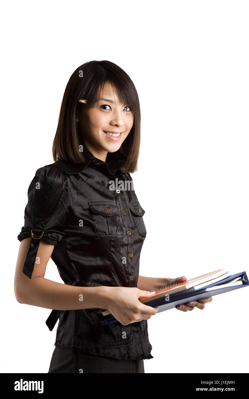 An isolated shot of a beautiful asian student carrying books Stock ...