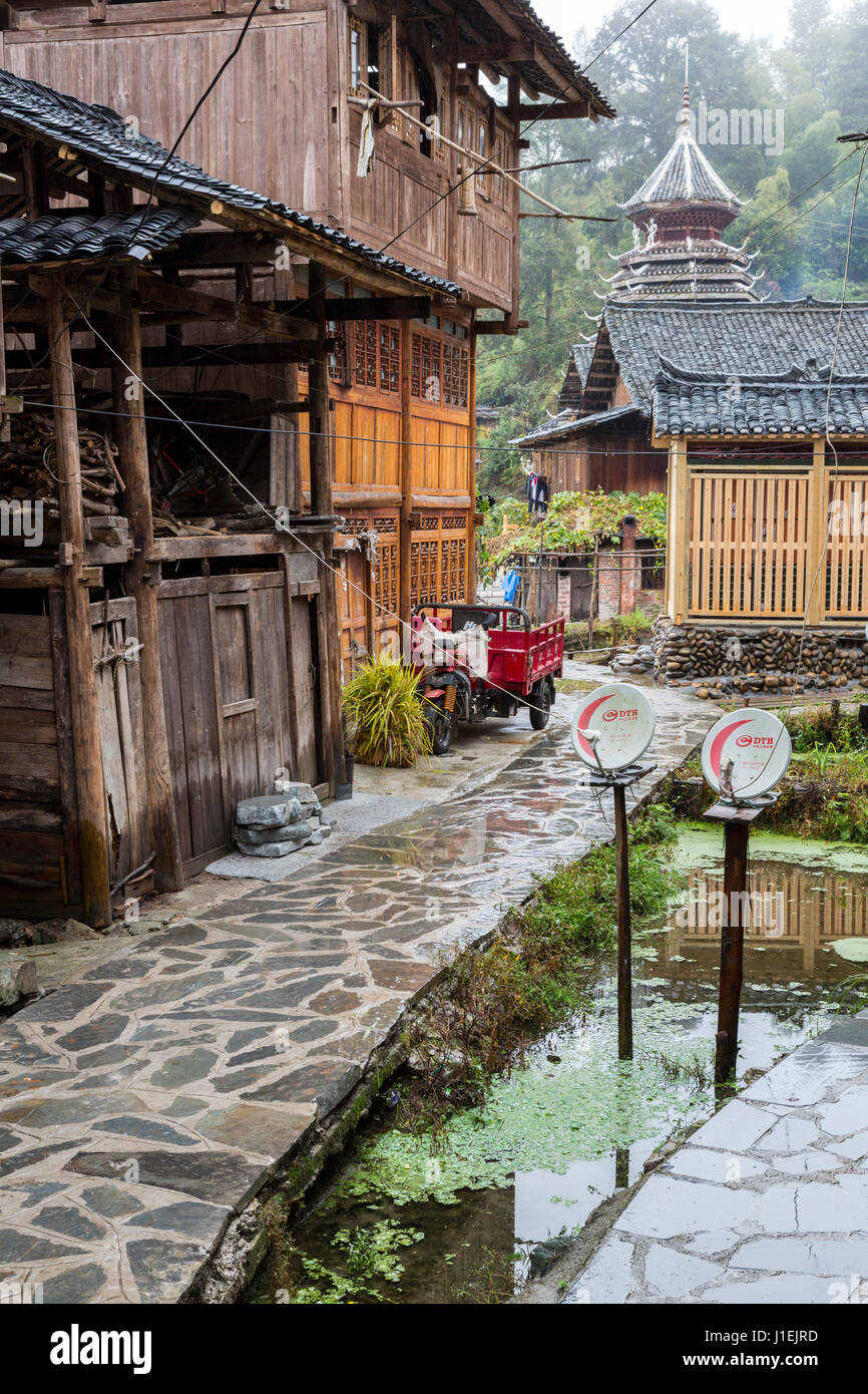 Huanggang, Guizhou, China.  A Dong Ethnic Village.  House, Satellite Dishes, Drum Tower in Background. Stock Photo