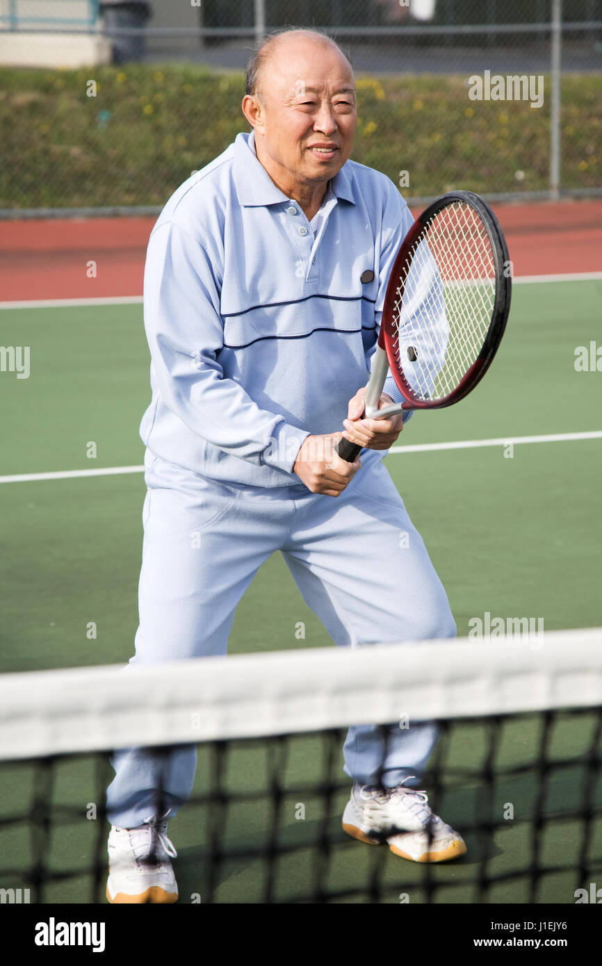 A shot of a senior asian man playing tennis Stock Photo - Alamy