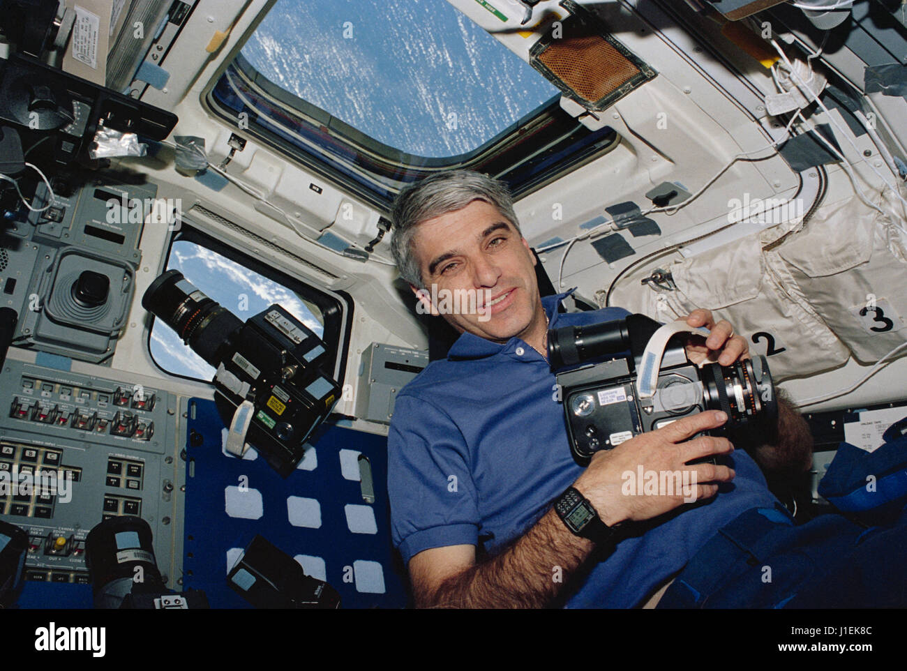 NASA STS-59 Space Radar Laboratory (SRL-1) mission astronaut Sidney Gutierrez uses a 70mm Hasselblad camera to capture images from out of the Space Shuttle Endeavour flight deck windows April 14, 1994 in Earth orbit.      (photo by NASA Photo /NASA   via Planetpix) Stock Photo