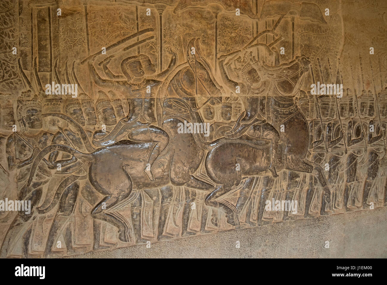 Decorations in bas-reliefs with,Warriors and horses, Temple of Angkor Wat Stock Photo