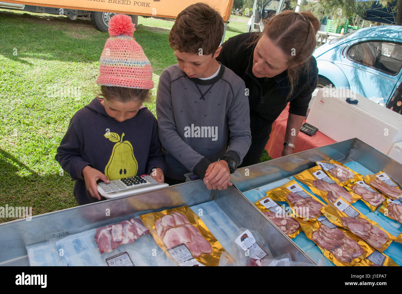 Stallholder's children learning to add up purchases at Gasworks Farmers Market, Port Melbourne, Victoria, Australia Stock Photo