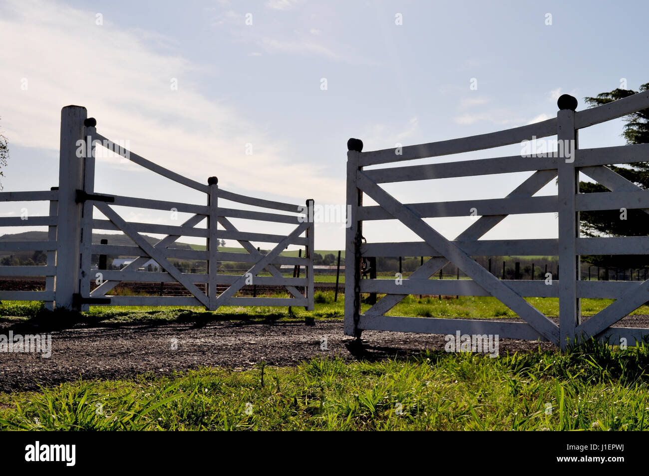 Farm entrance gate landscape background Stock Photo