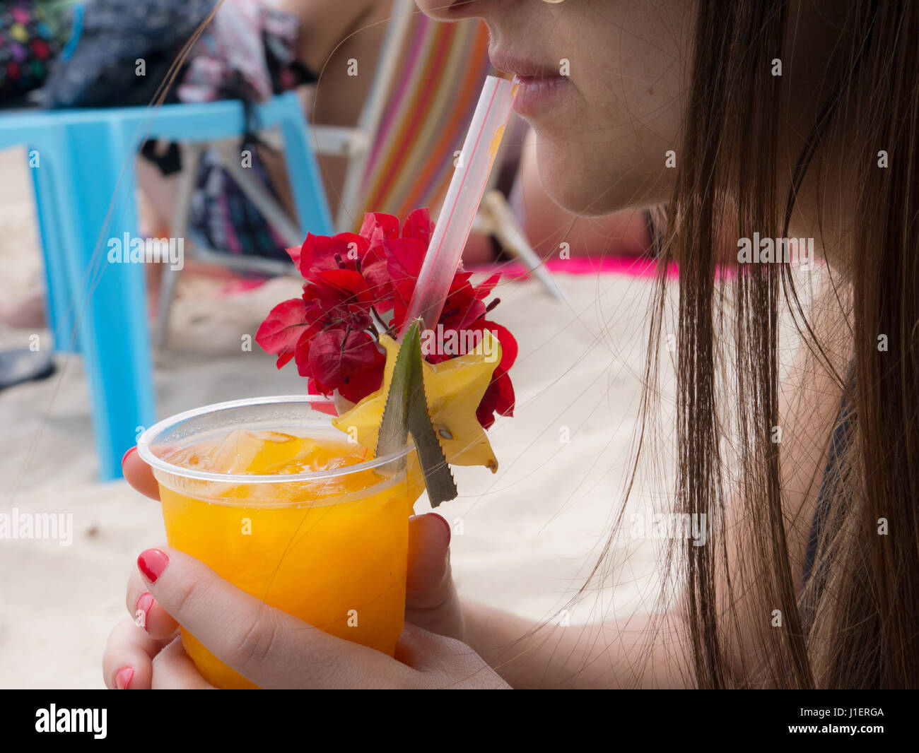 Latin woman drinks mango juice at beach Stock Photo Alamy