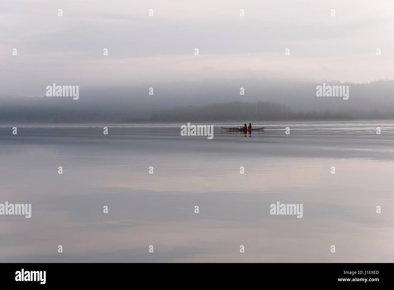 Canoeing on the Columbia river in fog weather. The silence of nature soothes and relaxes two people along Columbia Gorge area Stock Photo