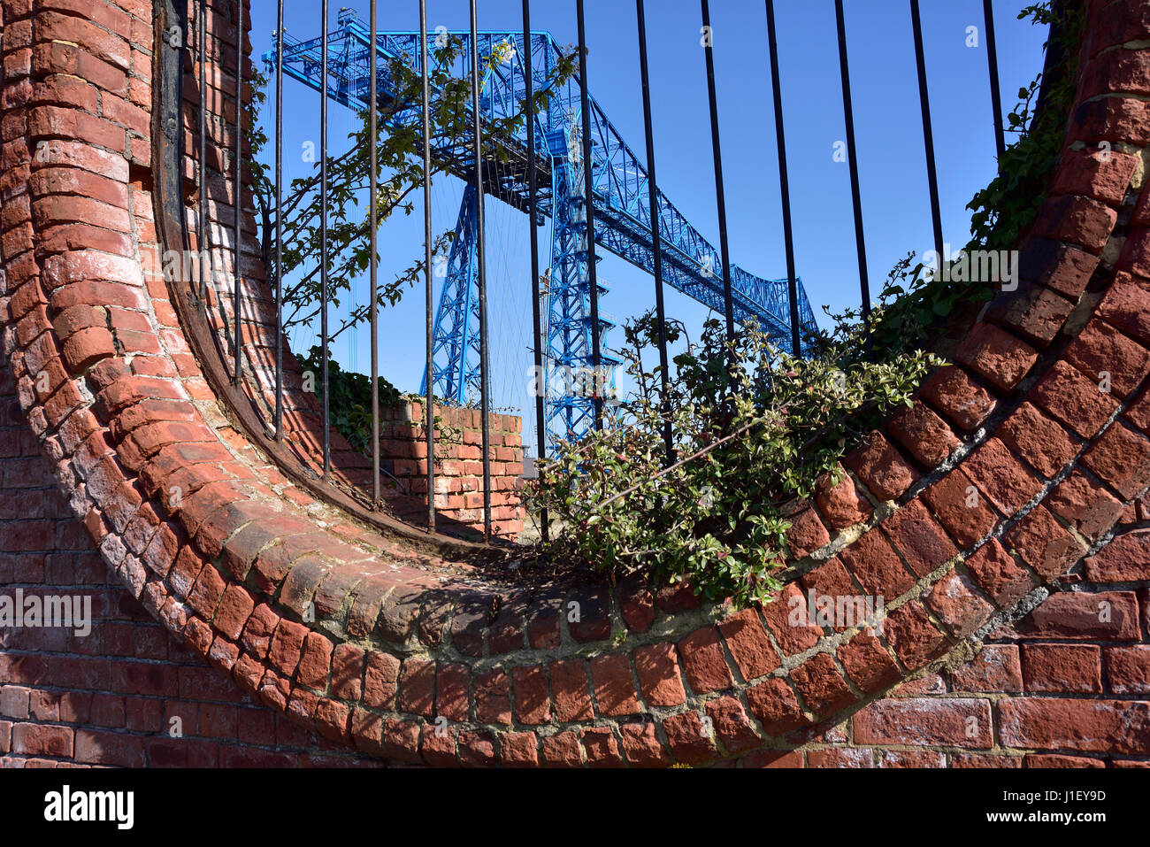 The Transporter Bridge over the River Tees,  Middlesbrough, seen through an oval opening in Vulcan Street Wall Stock Photo