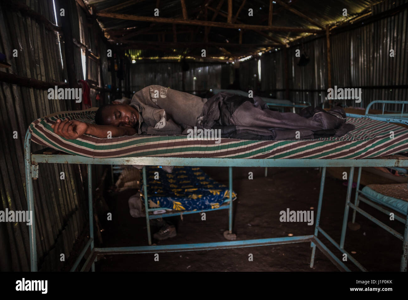 An exhausted former DRC militia member soon after repatriation to the Rwandan re-education and reintegration camp of Mutoba Stock Photo