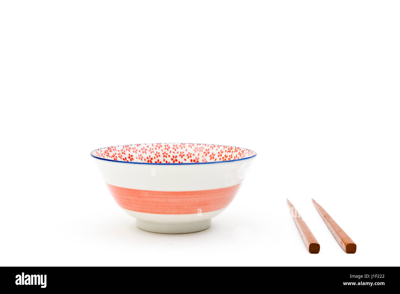 Empty bowl with chopsticks isolated on a white background Stock Photo