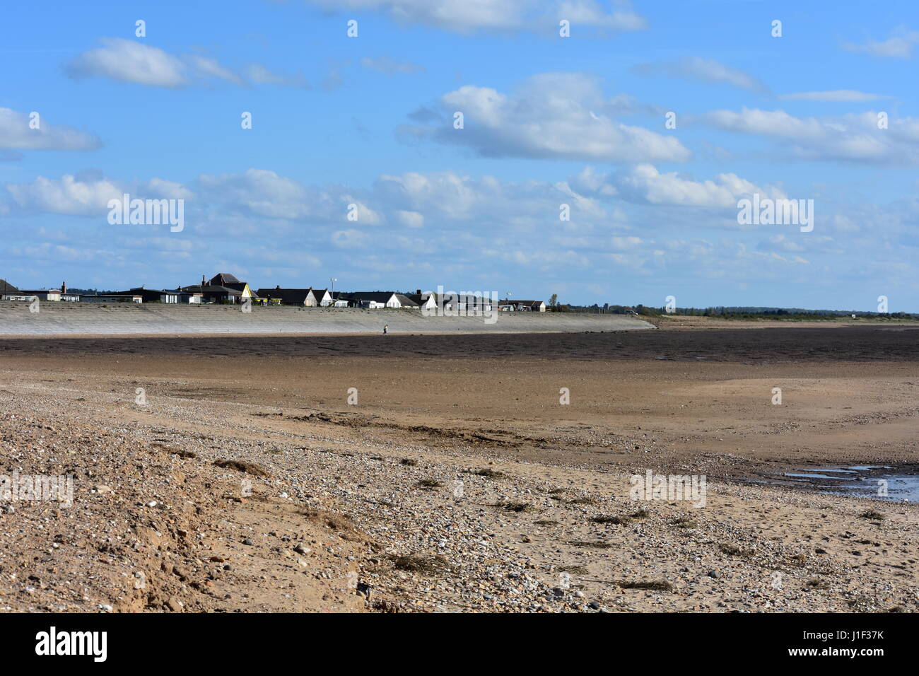 Snettisham Beach Chalets and Sea Defense at Low Tide, Snettisham, Norfolk, United Kingdom Stock Photo