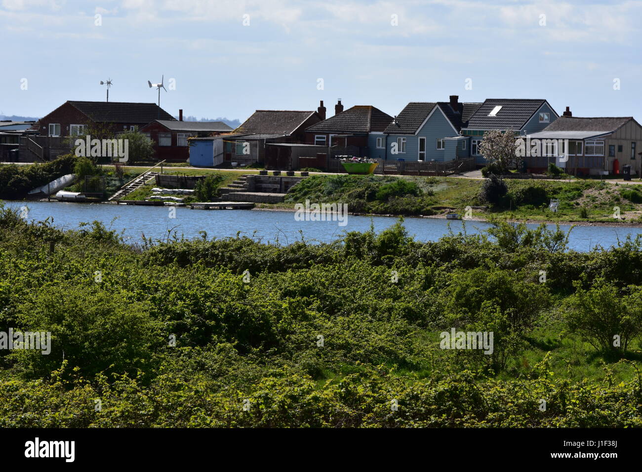 Lake with rear of Beach Chalets, Norfolk, United
