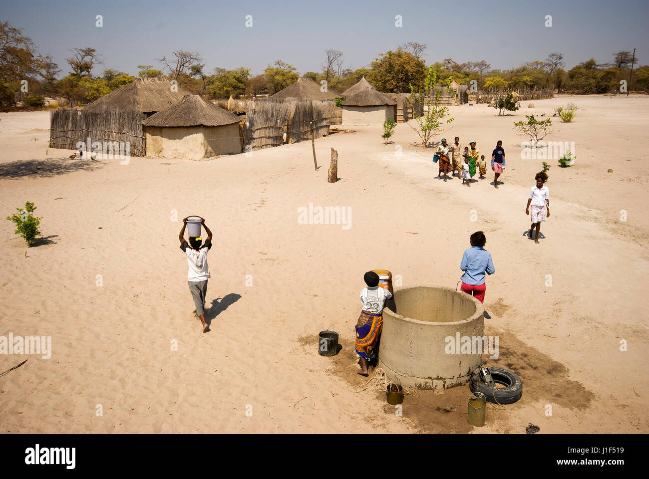 African people fetching water at the dry Caprivi Strip, Namibia Stock Photo