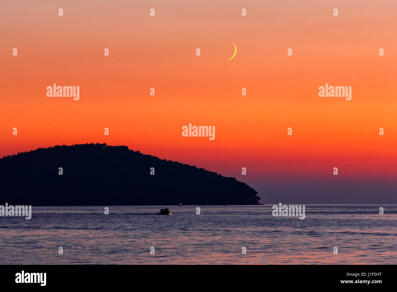 Sunset on island Korcula in Croatia with crescent moon on the sky Stock Photo