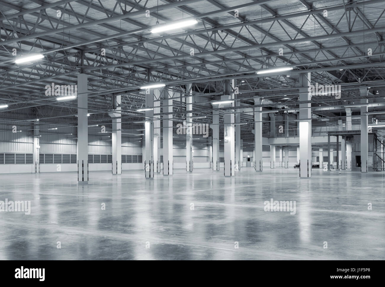 Empty factory building or warehouse building with concrete floor for background. Stock Photo