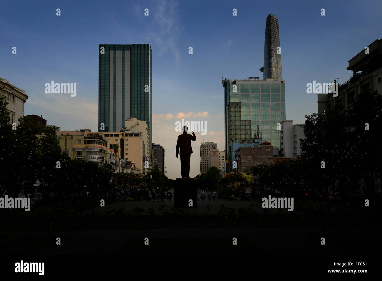The Silhouetted statue of Ho Chi Minh (Uncle Ho) which stands in Ho Chi Minh Square against the backdrop of the modern Ho Chi Minh city skyline. Stock Photo