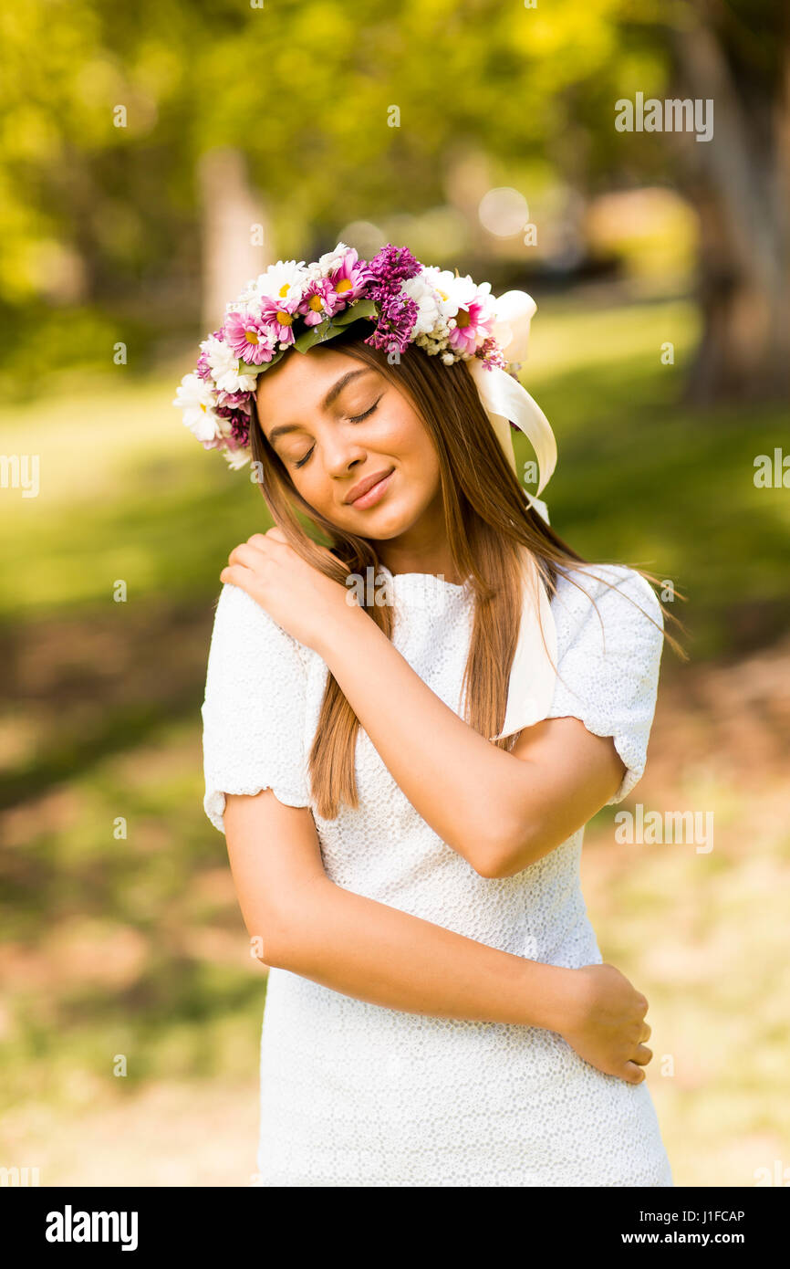 Pretty young woman with flowers in her hair on sunny spring day Stock ...