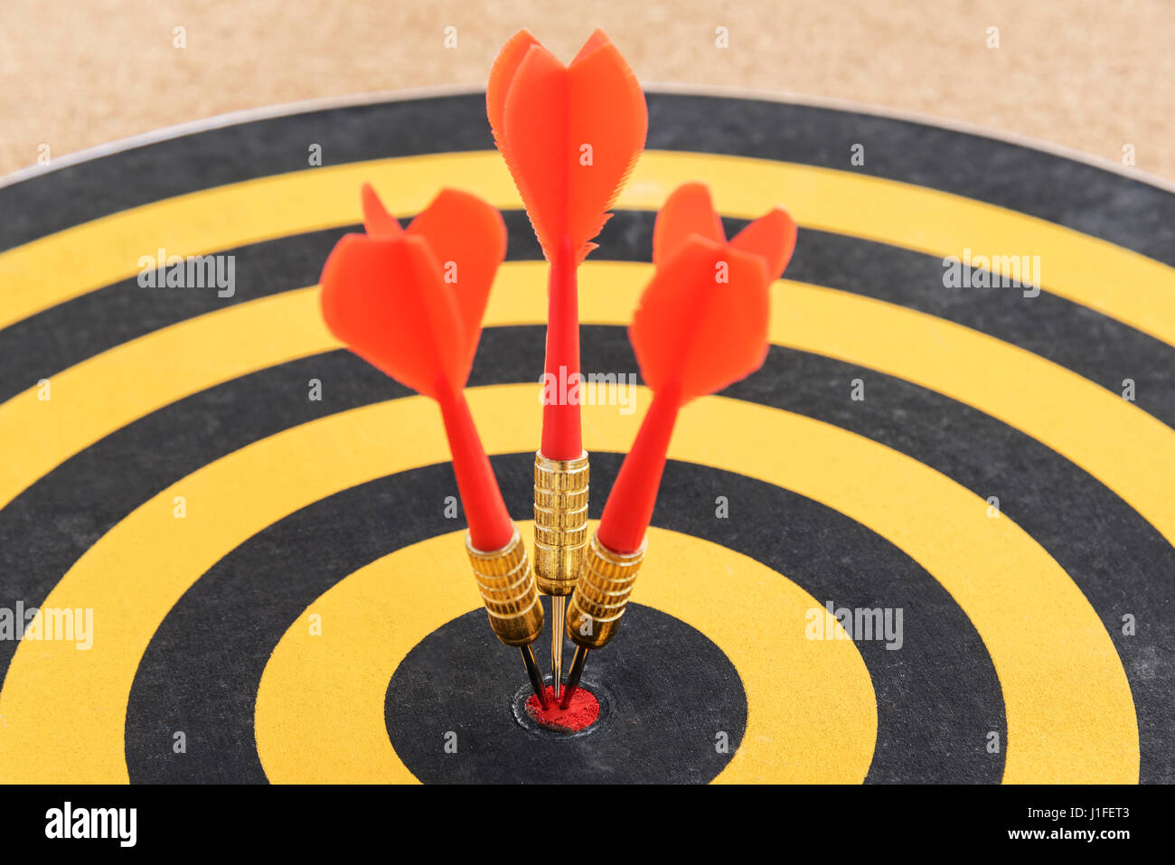 closeup one target with three dart arrows hitting the bullseye (goal). success business teamwork concept, abstract background Stock Photo