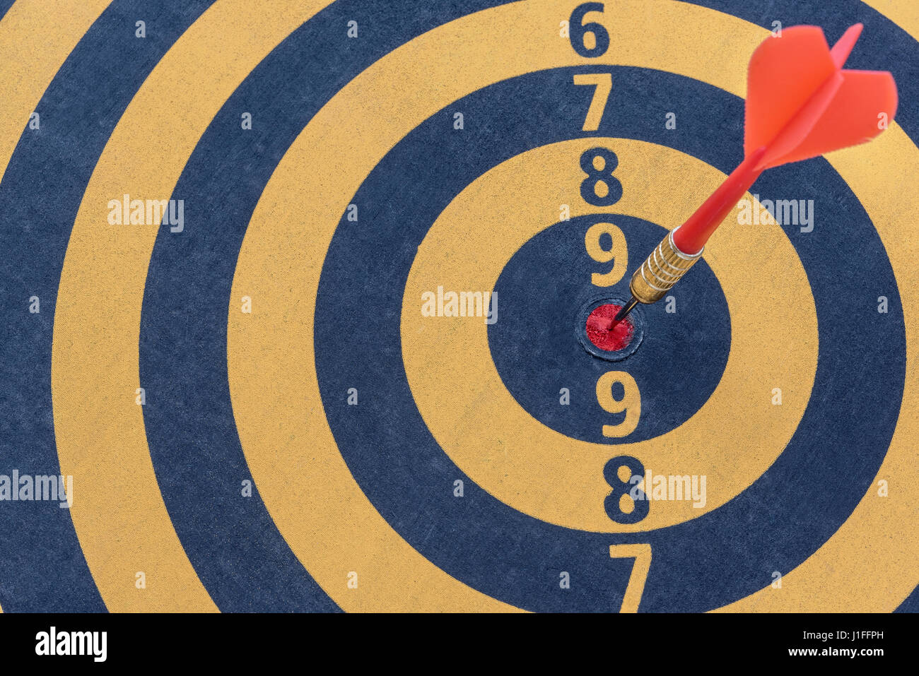 Dart target with arrow on bullseye, Goal target success business investment financial strategy concept, abstract background Stock Photo