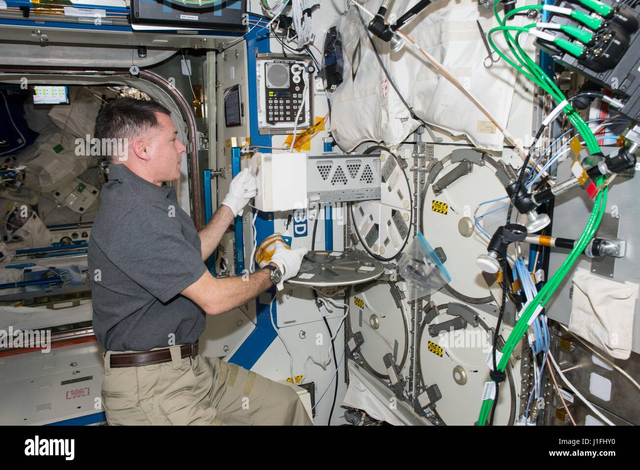 NASA Expedition 50 prime crew member American astronaut Shane Kimbrough removes a storage locker in the International Space Station Minus Eighty-degree Laboratory Freezer for ISS (MELFI) to store experimental samples March 15, 2017 in Earth orbit.       (photo by NASA Photo /NASA   via Planetpix) Stock Photo