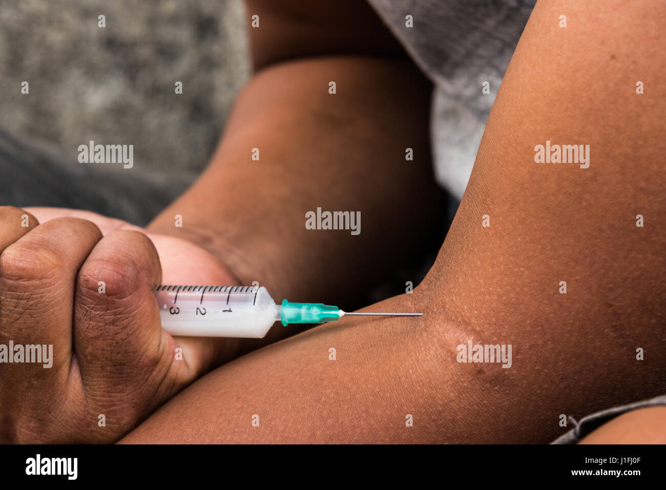 Teenager hand with heroin syringe closeup, narcotic drugs addiction concept Stock Photo