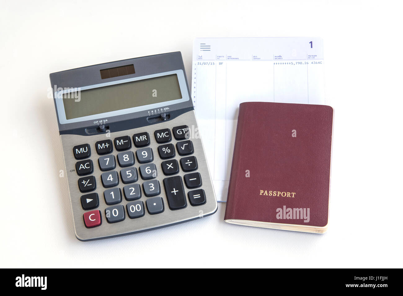 passport calculator and saving account passbook on white background Stock Photo