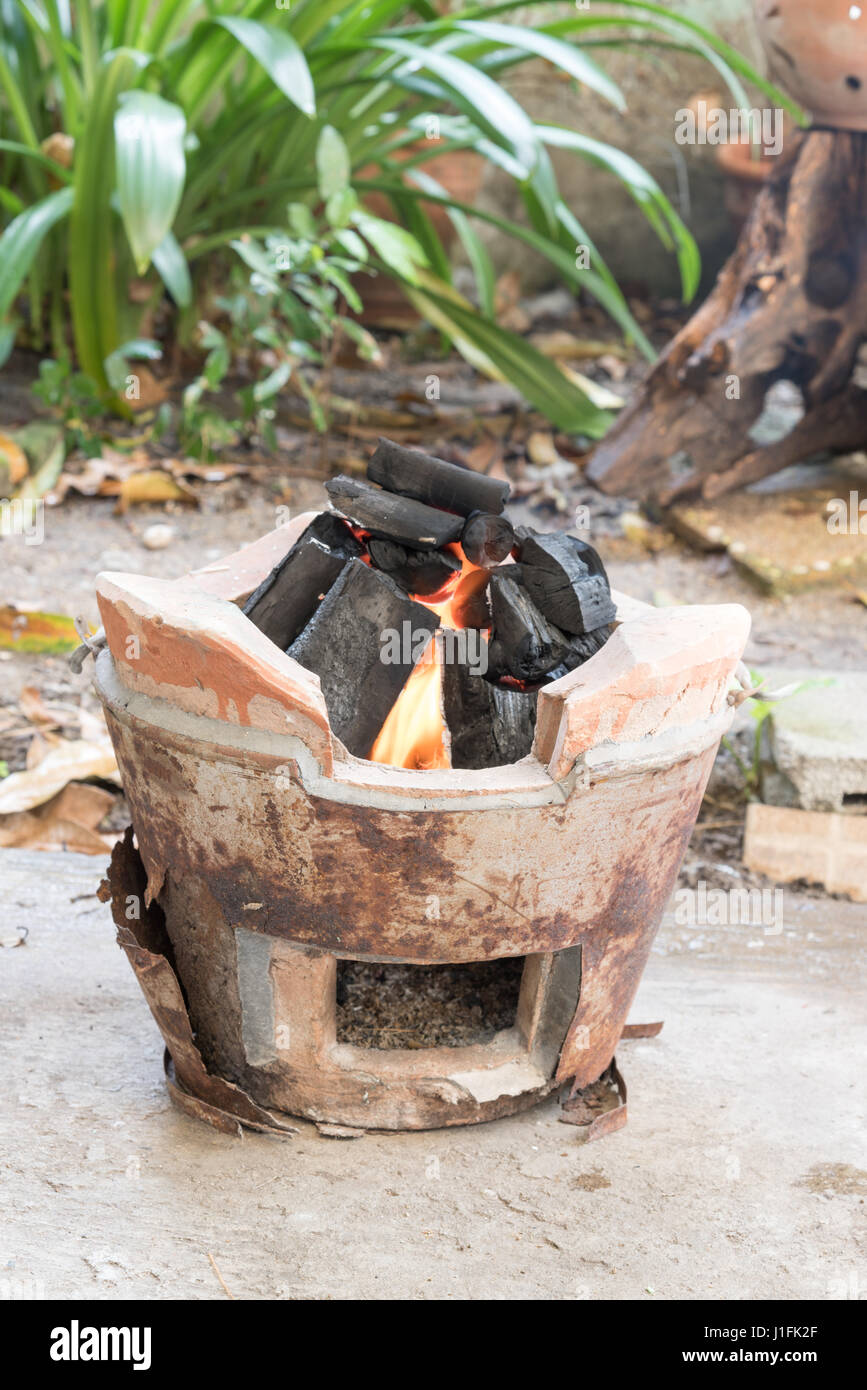 traditional charcoal burning clay stove with fire and blaze Stock Photo -  Alamy