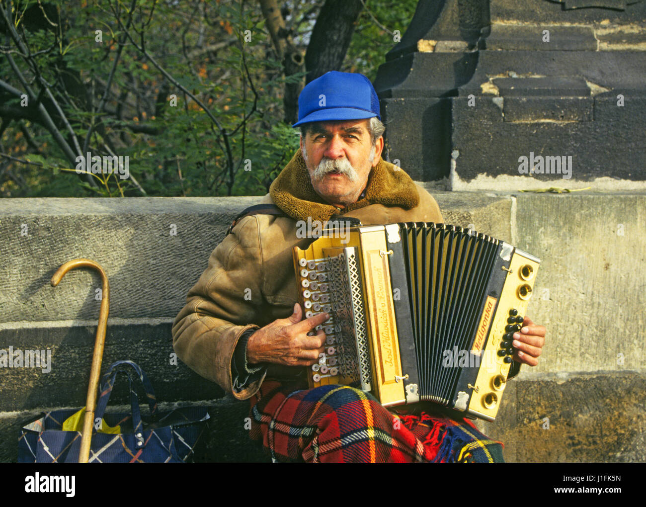 An old man playing the accordian on the Charles Bridge in downtown Prague, Czech Republic Stock Photo