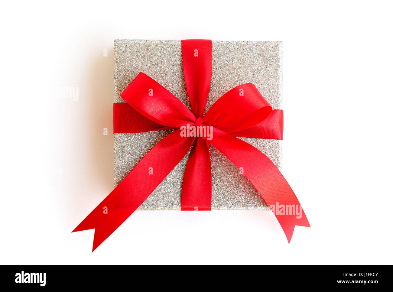 Silver gift box with red ribbon on white background with clipping path ...