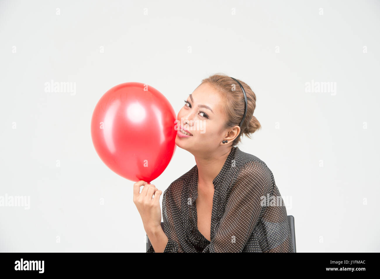Happy beautiful asian girl play with the red balloon Stock Photo - Alamy