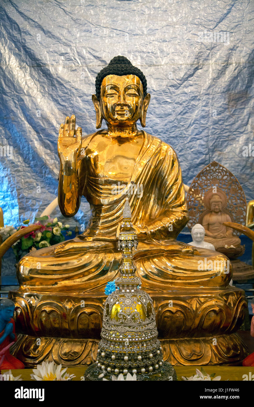 Kandy Sri Lanka Temple of the Sacred Tooth Golden Buddha with Usnisa and In Vitarka Mudra Gesture of discussion and transmission of Buddha's teaching  Stock Photo