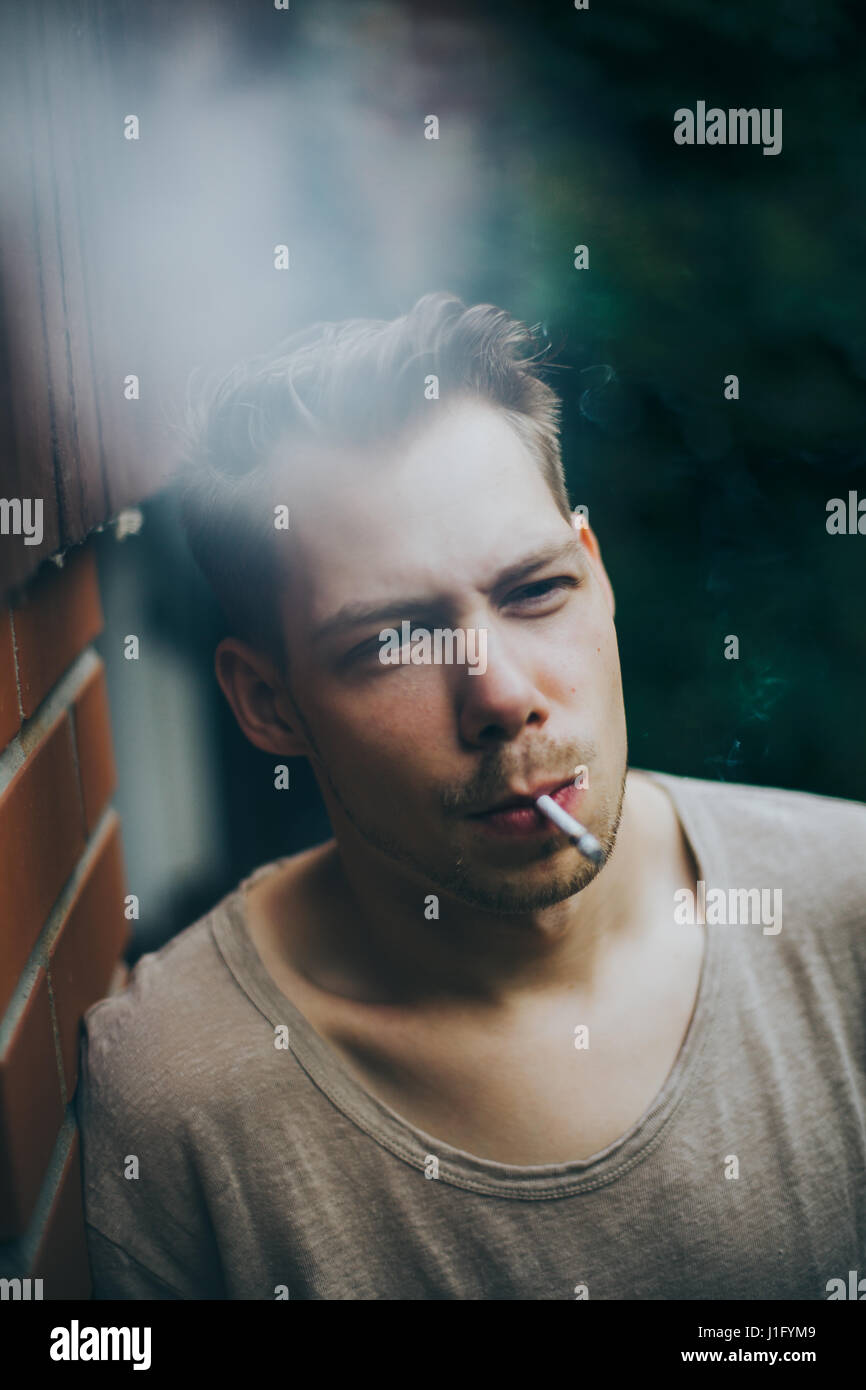 Young hipster man smoking Stock Photo