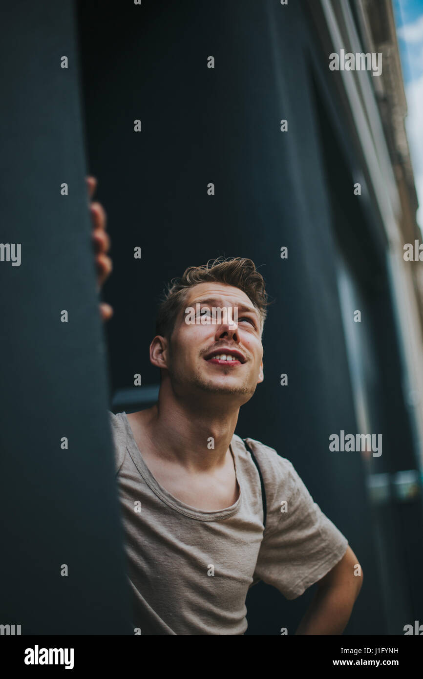 Young hipster man looking up in the sky Stock Photo