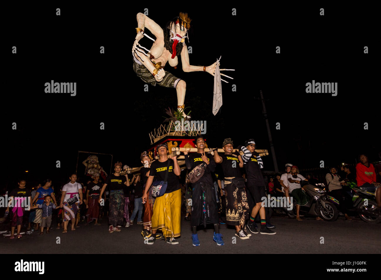 Scary OgohOgoh witch with long fingers being carried by group of