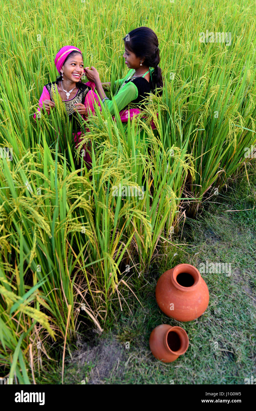 Two adolescent girl making fun at the agricultural land in West Bengal