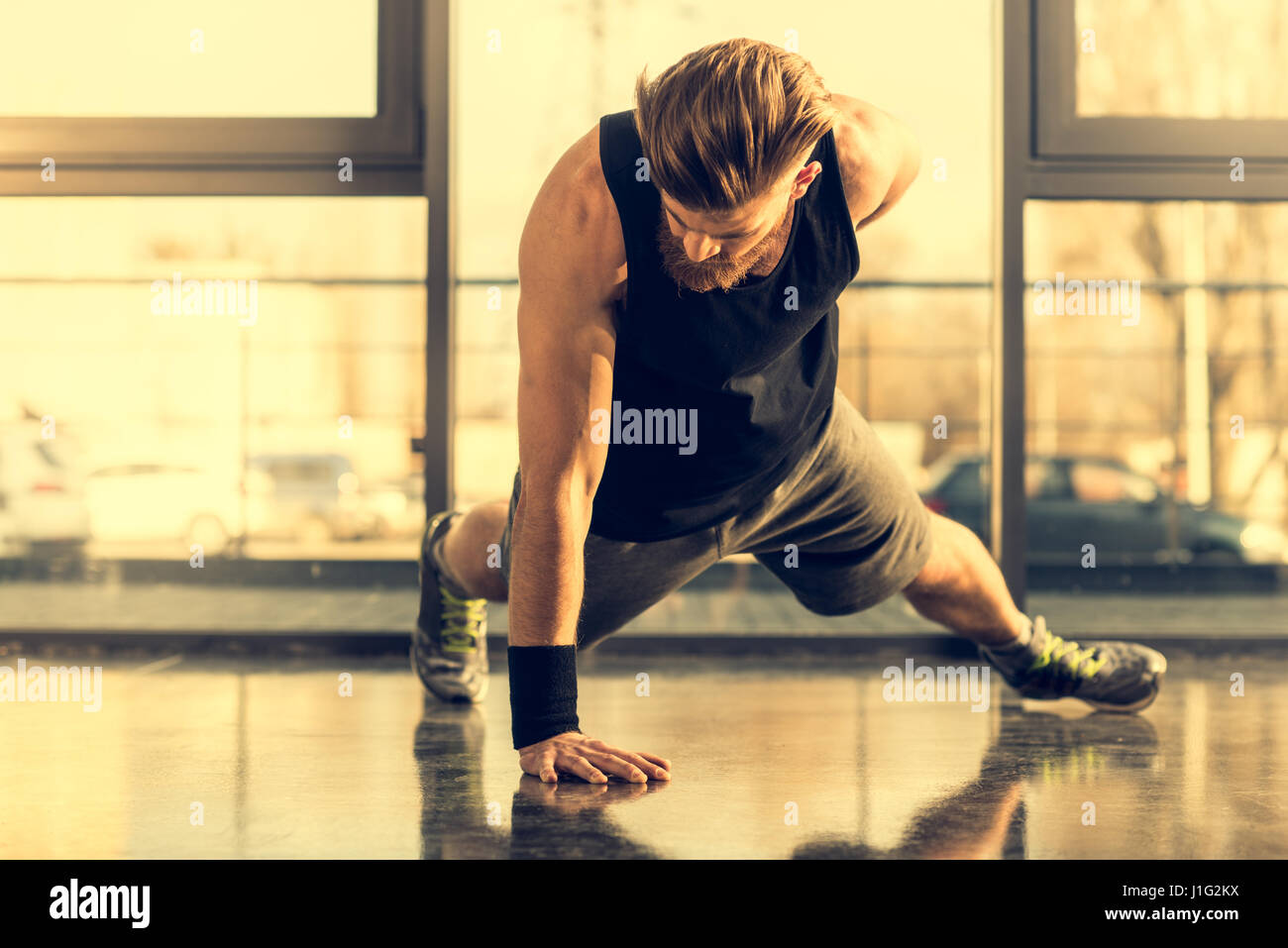Young handsome bearded man doing push ups exercise in gym Stock Photo ...