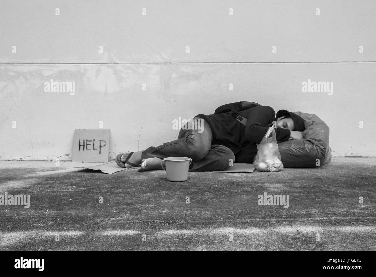 Homeless person sleep on sidewalk of the street Stock Photo Alamy