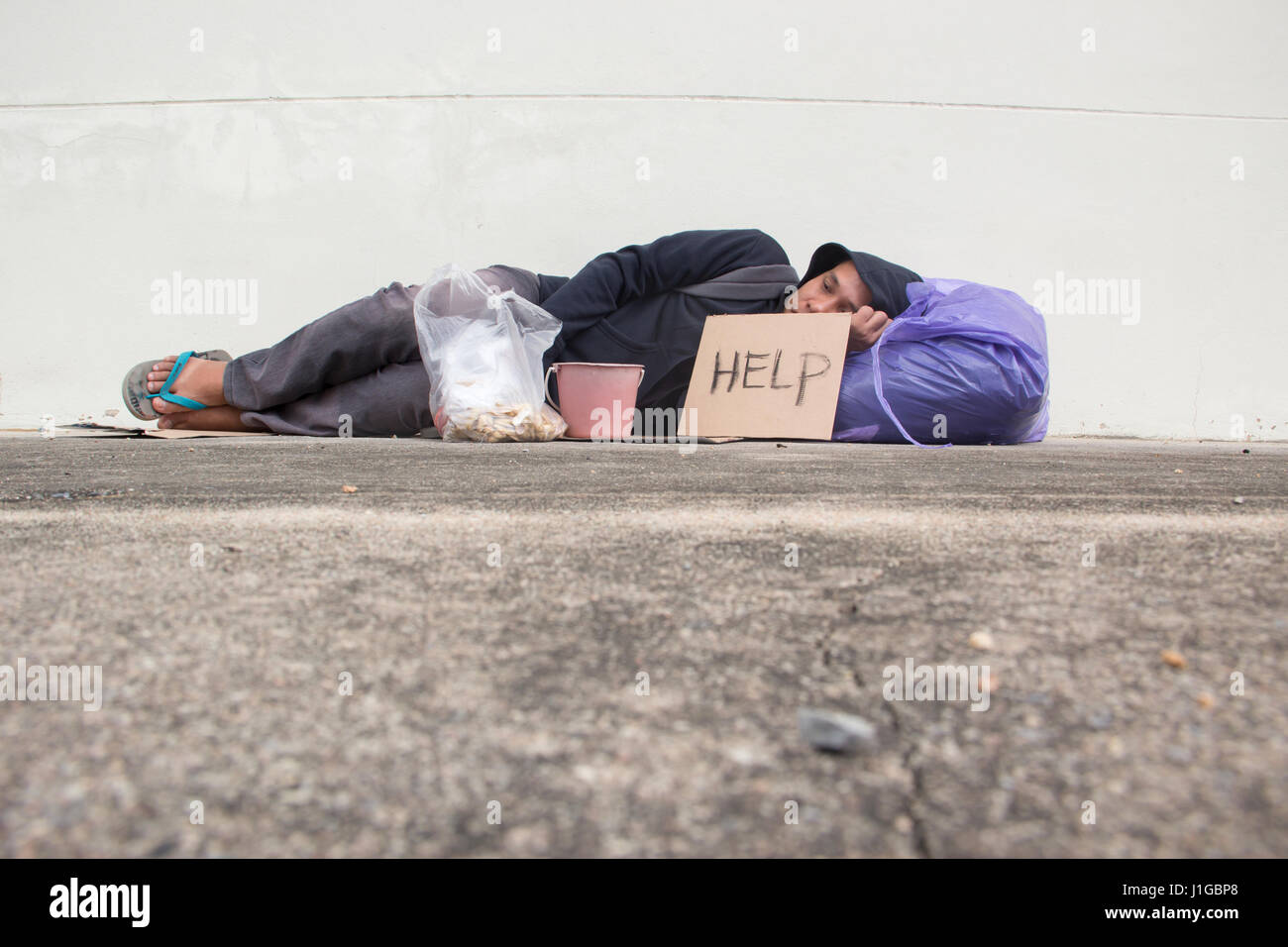 Homeless person sleep on sidewalk of the street Stock Photo Alamy
