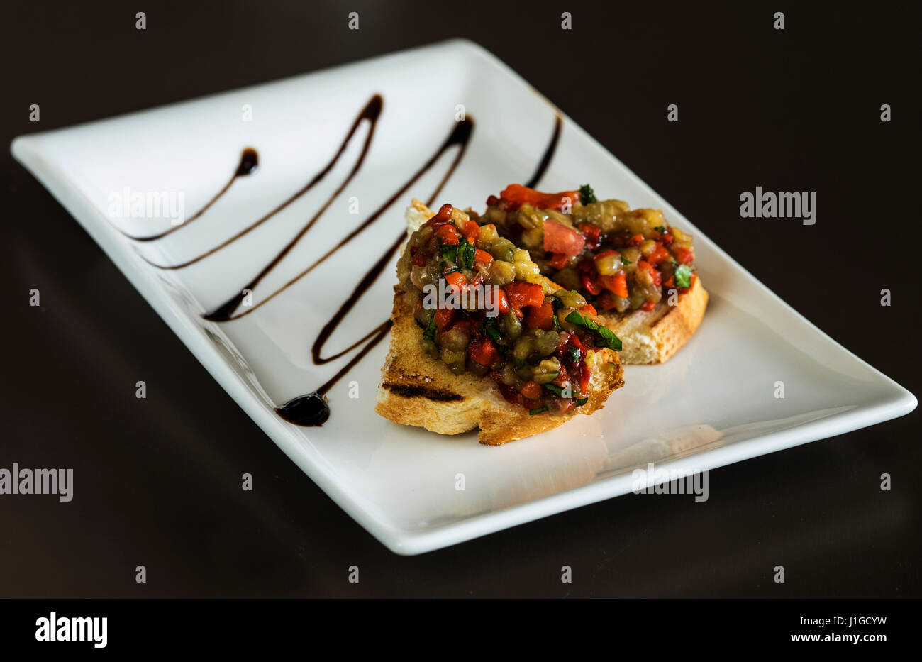 Selection of tasty bruschetta or canapes on taosted baguette with eggplant Stock Photo