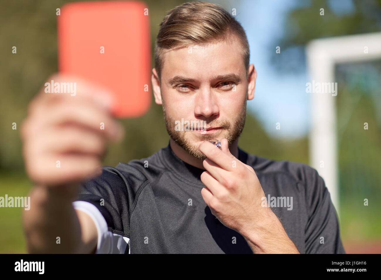 referee on football field showing red card Stock Photo Alamy