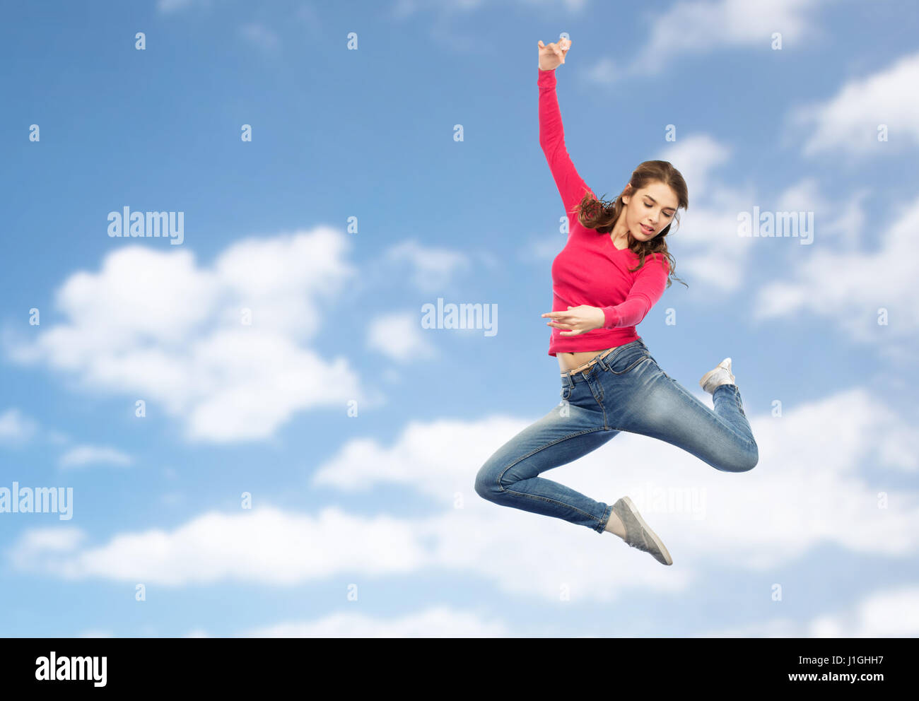 smiling young woman jumping in air Stock Photo - Alamy