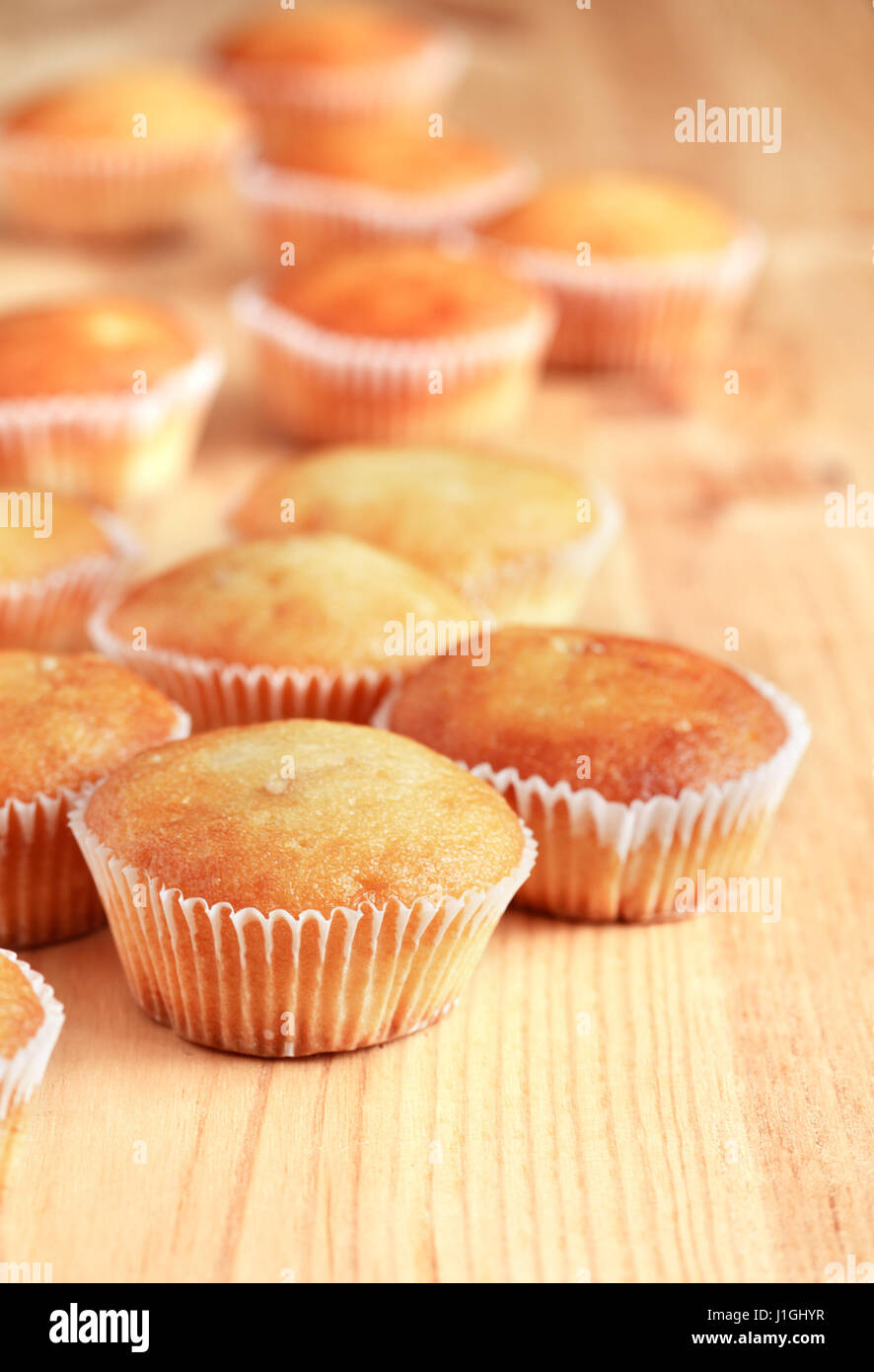 Set of  fresh-baked muffins on wooden surface Stock Photo