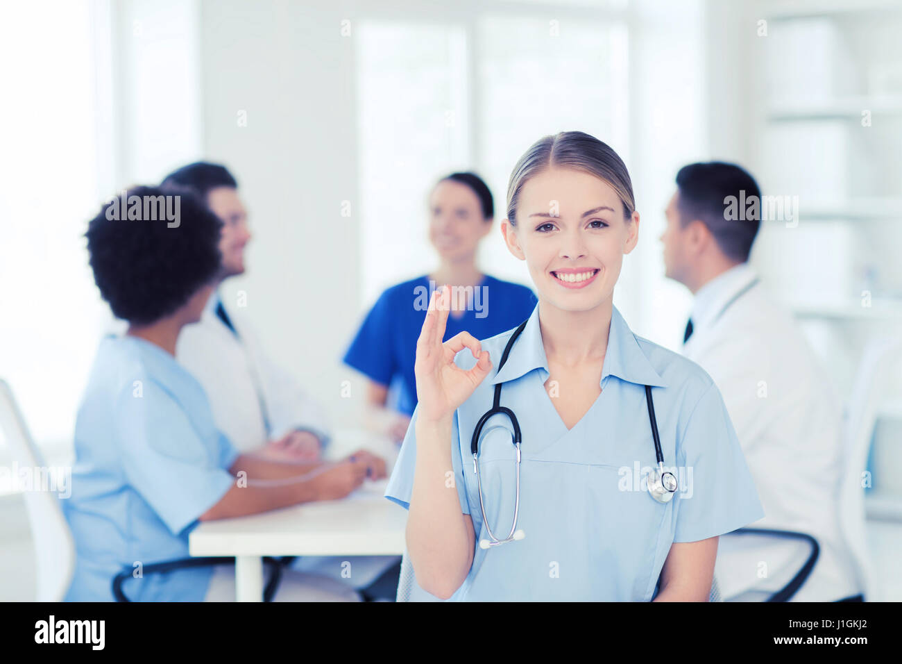 Happy black doctor sitting hi-res stock photography and images - Alamy